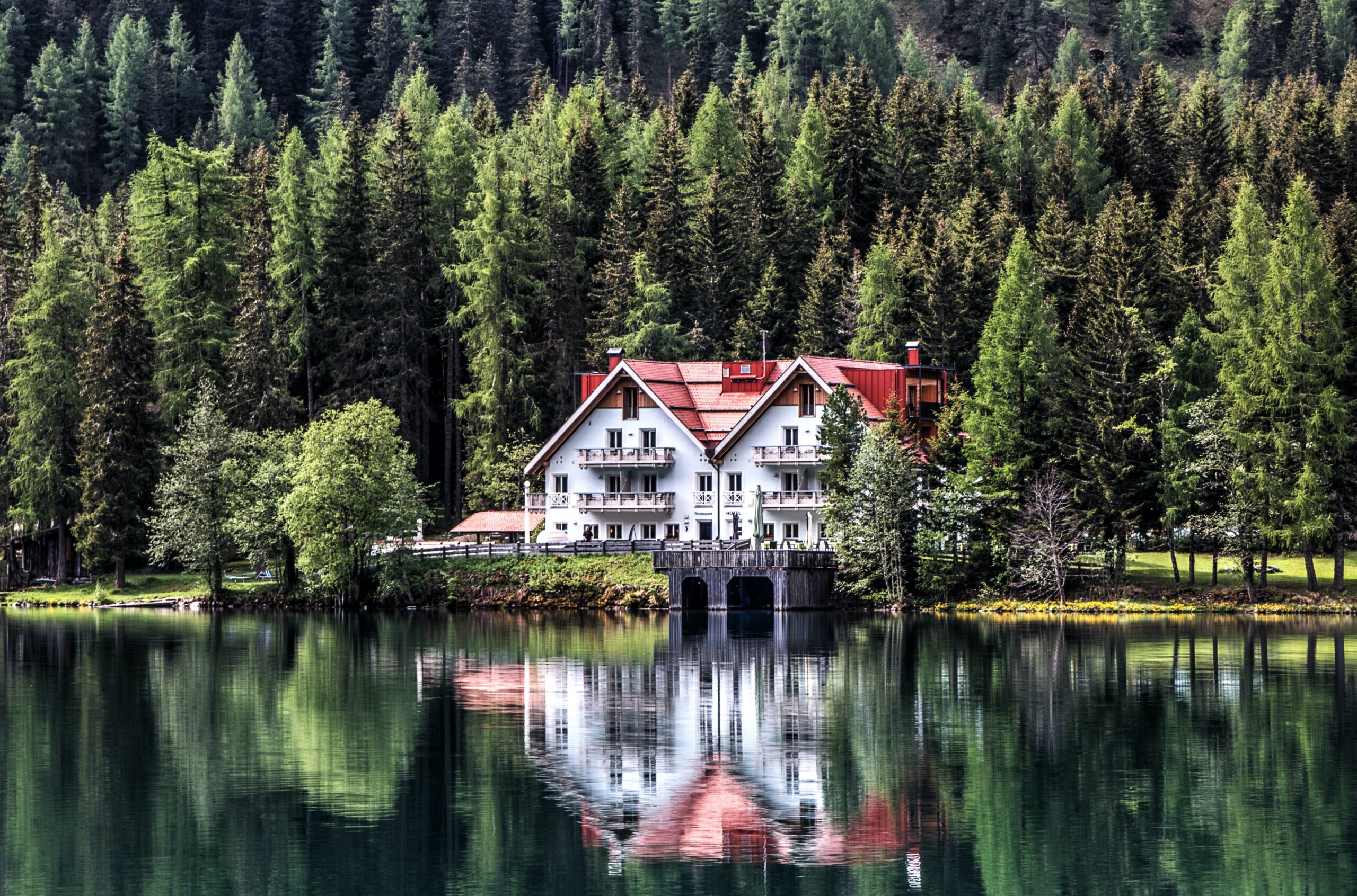 Beautiful home with a reflection in the lake.